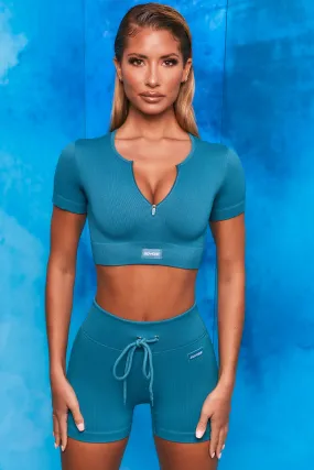 Perform Ribbed Short Sleeve Zip Front Crop Top in Teal